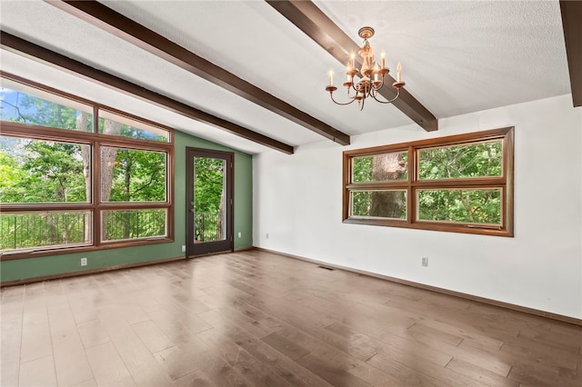 3044 Greenlake Dr, Decatur, IL 62521 - unfurnished room with a chandelier, plenty of natural light, and wood finished floors