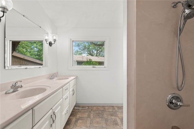 3044 Greenlake Dr, Decatur, IL 62521 - full bath with healthy amount of natural light, double vanity, and stone finish flooring