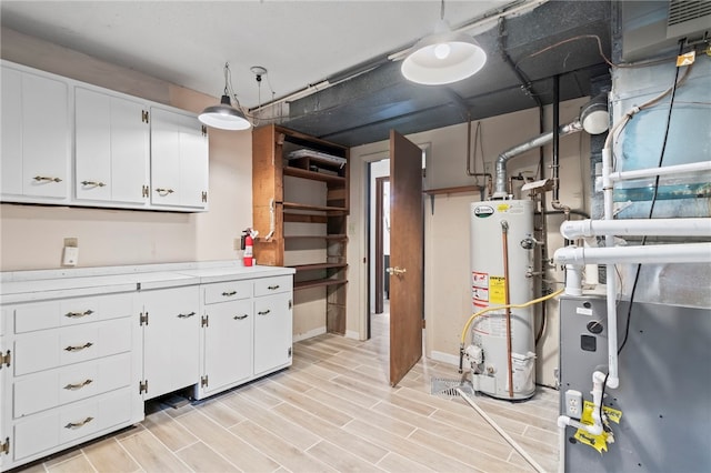 3044 Greenlake Dr, Decatur, IL 62521 - basement with gas water heater, light wood-style floors, and heating unit