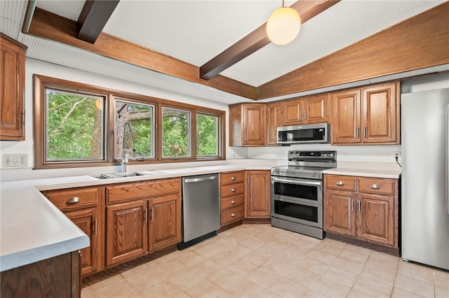 3044 Greenlake Dr, Decatur, IL 62521 - kitchen with appliances with stainless steel finishes, brown cabinets, light countertops, and light tile patterned floors