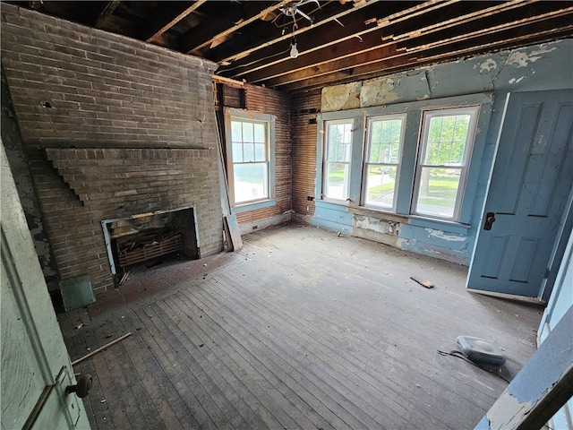 unfurnished living room featuring a fireplace and wood-type flooring