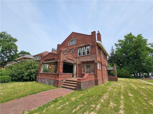 528 E Broadway St, Centralia, IL 62801 - view of front of home featuring brick siding, a front lawn, and a chimney