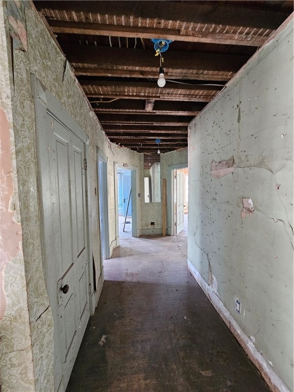 hallway featuring beam ceiling