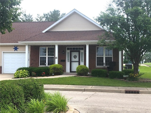 8 Courtyard Blvd, Sullivan, IL 61951 - view of front of home with a garage, brick siding, concrete driveway, a shingled roof, and a front yard