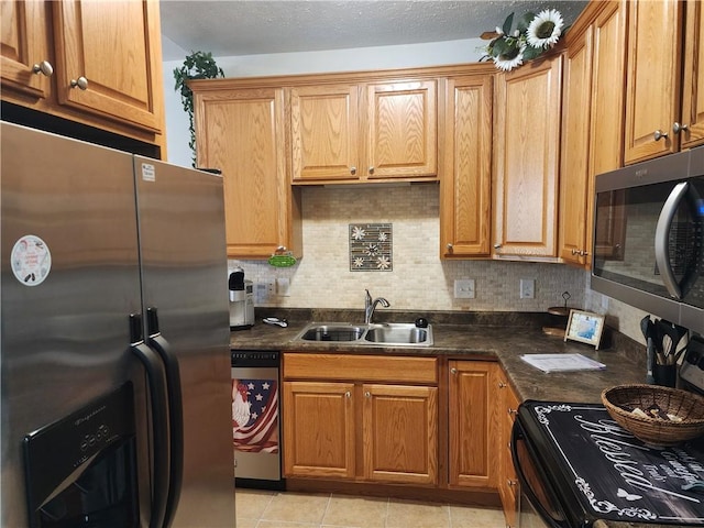 8 Courtyard Blvd, Sullivan, IL 61951 - kitchen with appliances with stainless steel finishes, a sink, dark countertops, and tasteful backsplash