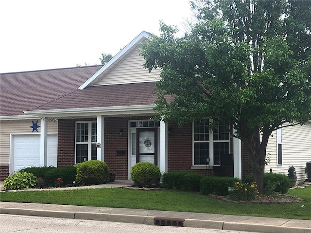 8 Courtyard Blvd, Sullivan, IL 61951 - view of front of property with brick siding, an attached garage, a front yard, and roof with shingles