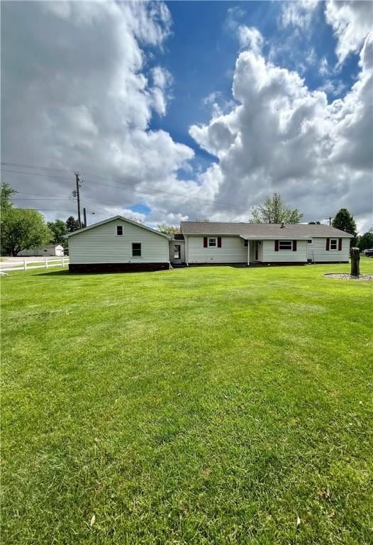 rear view of house with a lawn