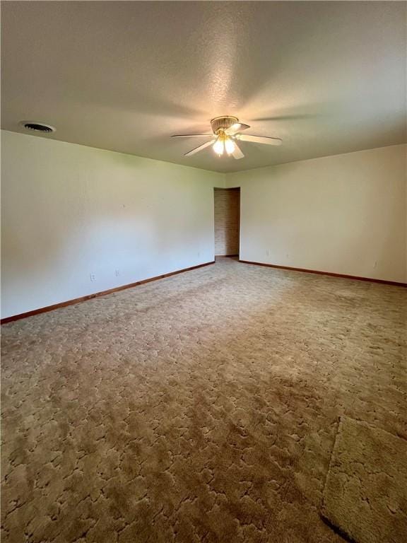 unfurnished room featuring a ceiling fan, baseboards, and carpet