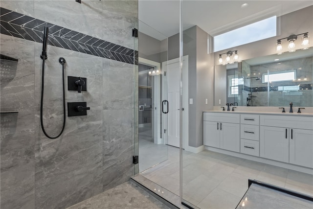 bathroom with tile patterned flooring, vanity, and a shower with shower door