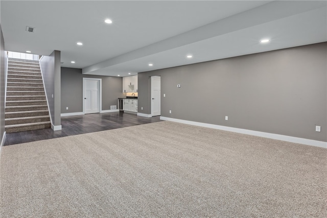 basement with dark hardwood / wood-style flooring