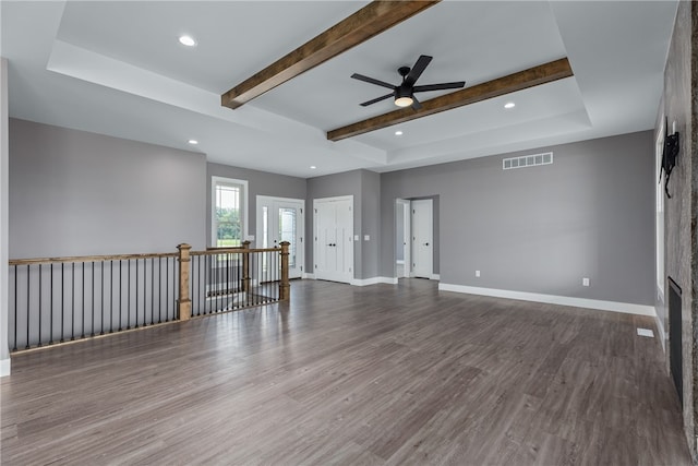 unfurnished room featuring beam ceiling, dark hardwood / wood-style floors, and ceiling fan