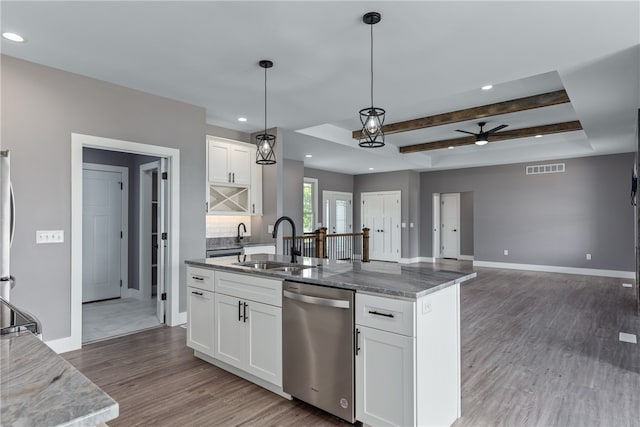 kitchen with sink, decorative backsplash, appliances with stainless steel finishes, beam ceiling, and white cabinetry