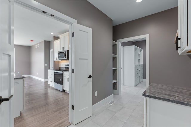 hallway with light hardwood / wood-style floors