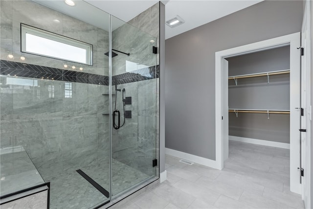 bathroom featuring a shower with door