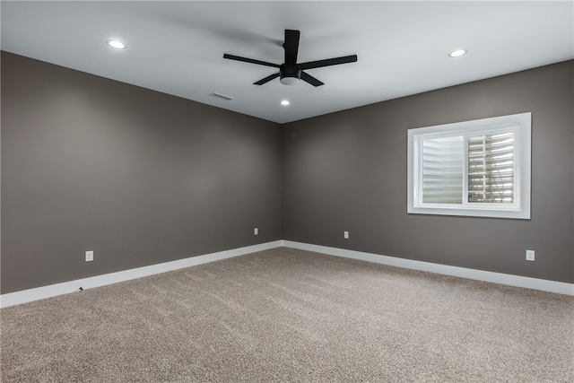 unfurnished room with carpet flooring and ceiling fan