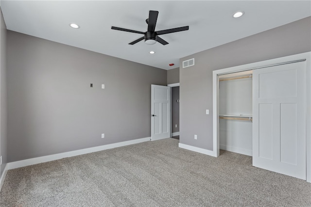 unfurnished bedroom with carpet, ceiling fan, and a closet