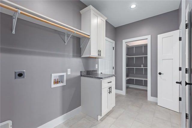 laundry room with cabinets, hookup for a washing machine, and electric dryer hookup