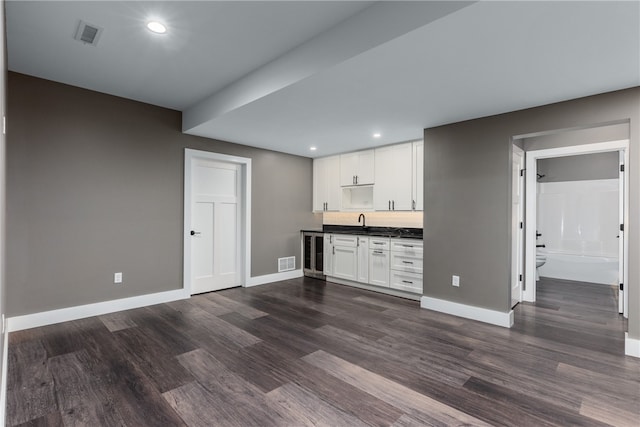 kitchen with sink, white cabinetry, dark wood-type flooring, and wine cooler