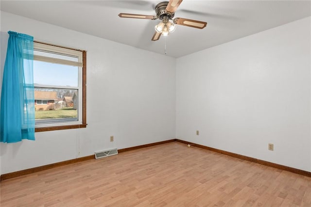 unfurnished room featuring visible vents, a ceiling fan, light wood-type flooring, and baseboards