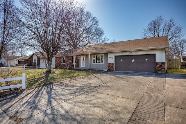 ranch-style home featuring fence, concrete driveway, a front yard, a garage, and brick siding