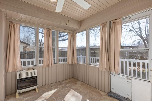 unfurnished sunroom with heating unit, wood ceiling, and ceiling fan