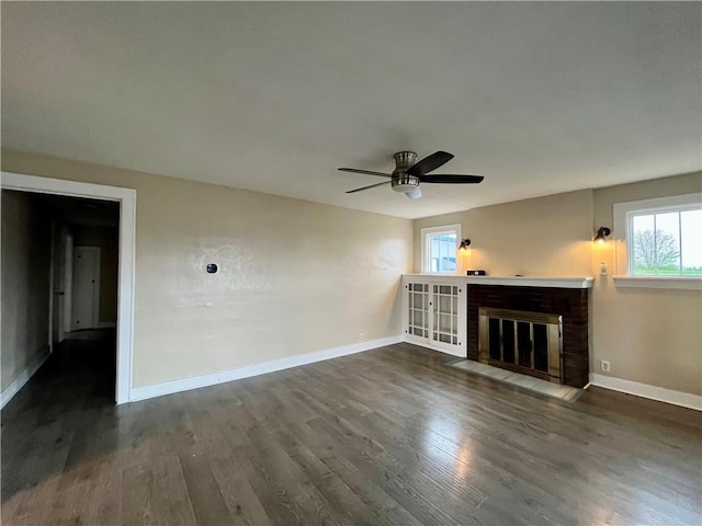 605 N 15th St, Mattoon, IL 61938 - unfurnished living room featuring baseboards, ceiling fan, a brick fireplace, and dark wood-style floors