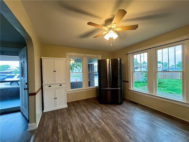 605 N 15th St, Mattoon, IL 61938 - empty room featuring baseboards, ceiling fan, dark wood-style floors, and a healthy amount of sunlight