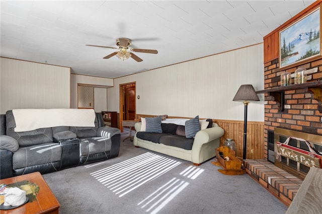 living room featuring ceiling fan, carpet, and a brick fireplace