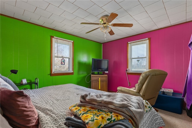 carpeted bedroom with multiple windows and ceiling fan