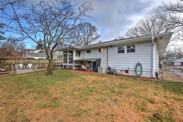 back of property featuring a lawn and a sunroom