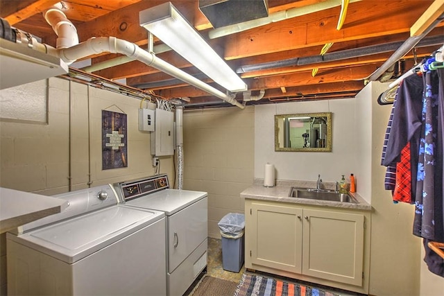 washroom with cabinets, electric panel, separate washer and dryer, and sink