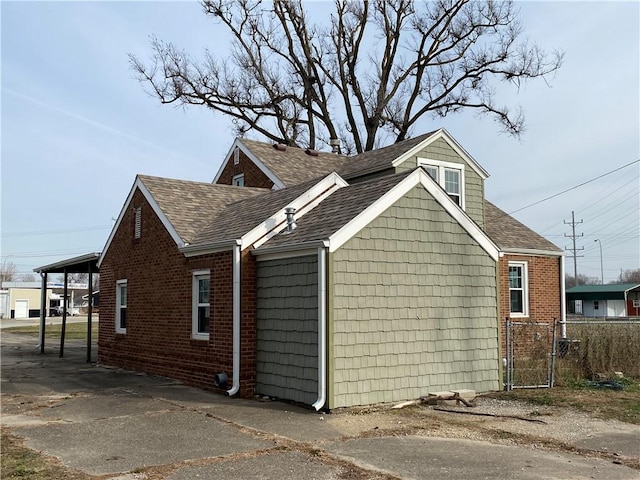 view of side of property featuring a carport