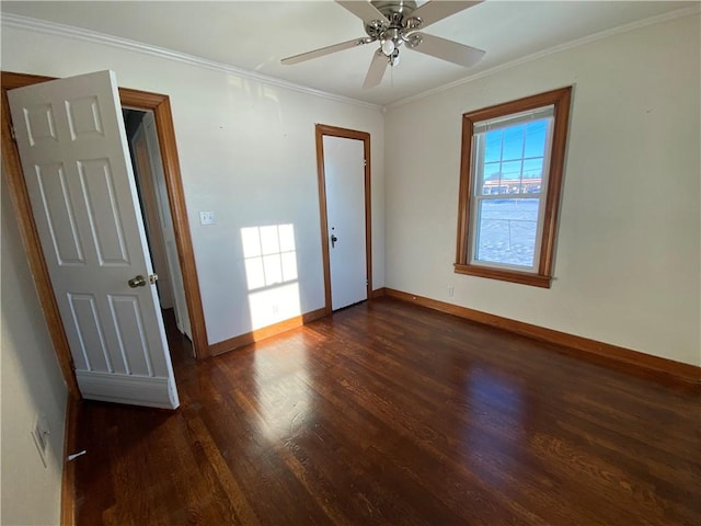 empty room with ceiling fan, crown molding, and dark wood-type flooring