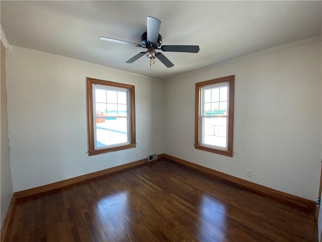 spare room with ceiling fan, dark hardwood / wood-style flooring, ornamental molding, and a wealth of natural light