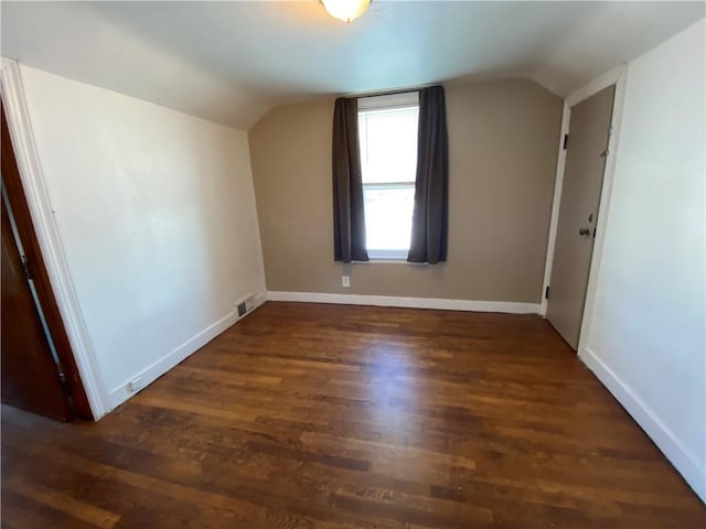 bonus room featuring vaulted ceiling and dark hardwood / wood-style floors