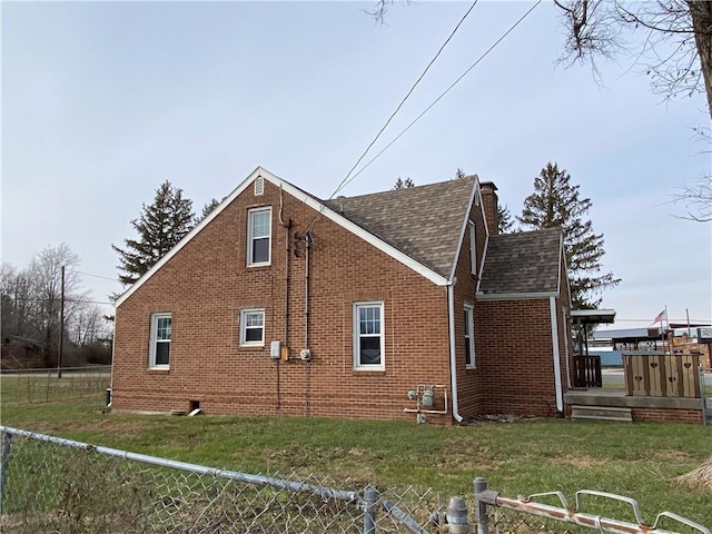 view of side of home with a yard