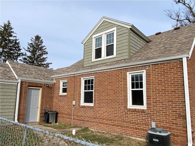 view of side of home featuring cooling unit