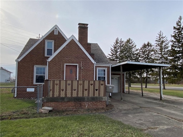 view of front facade with a carport, a front lawn, and a garage