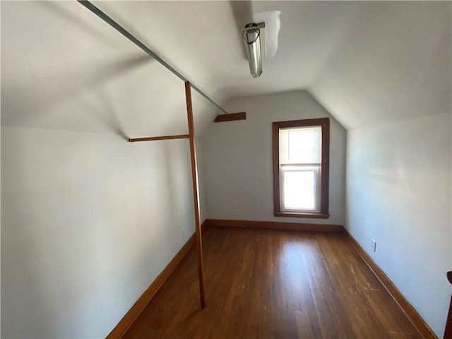 bonus room with lofted ceiling and dark wood-type flooring