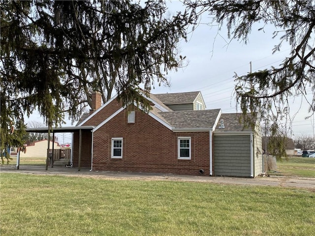 view of home's exterior featuring a lawn and a carport