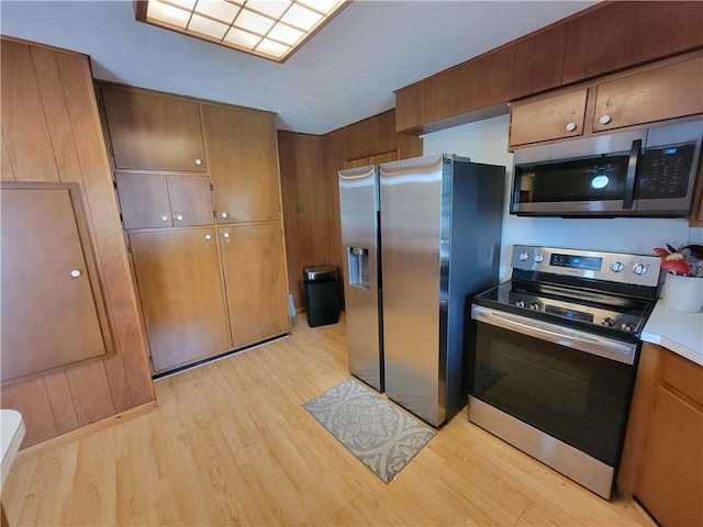505 W N 9th St, Shelbyville, IL 62565 - kitchen featuring appliances with stainless steel finishes, light wood finished floors, light countertops, and brown cabinetry