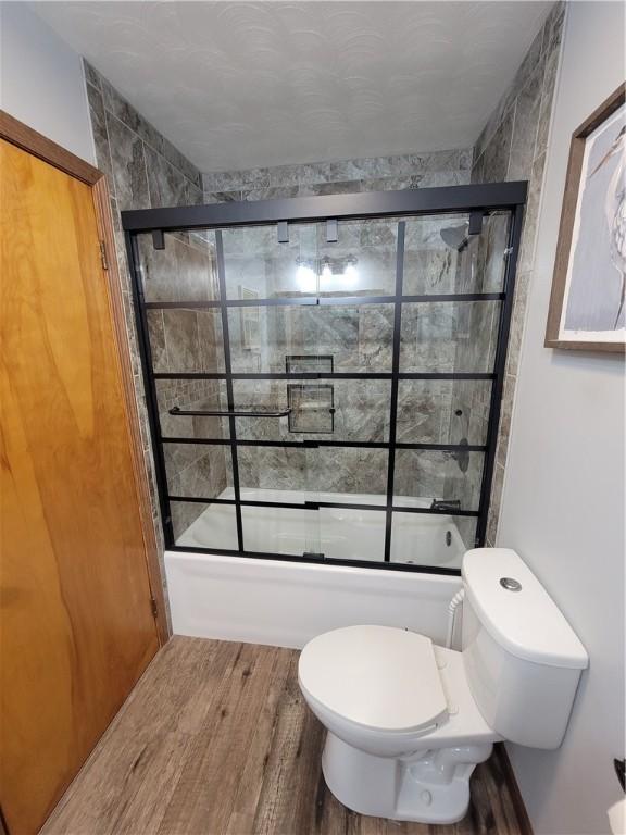 505 W N 9th St, Shelbyville, IL 62565 - bathroom featuring shower / bath combination with glass door and wood finished floors