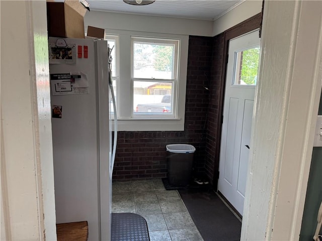 1007 10th St, Charleston, IL 61920 - bathroom with brick wall and tile patterned flooring