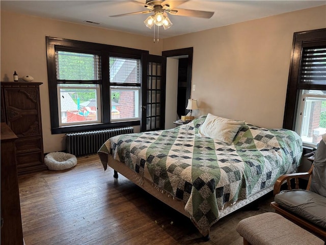 1007 10th St, Charleston, IL 61920 - bedroom with radiator heating unit, wood finished floors, and a ceiling fan