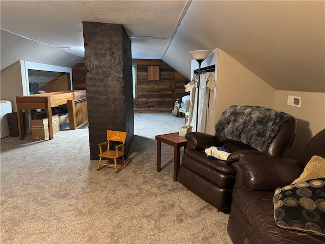 1007 10th St, Charleston, IL 61920 - living room with carpet flooring, lofted ceiling, washer / dryer, and wood walls