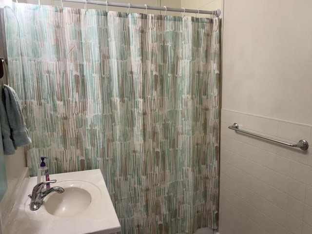 1216 Lawn Dr, Mattoon, IL 61938 - full bathroom with a shower with curtain, vanity, and tile walls