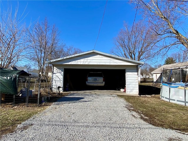 detached garage with an outdoor pool