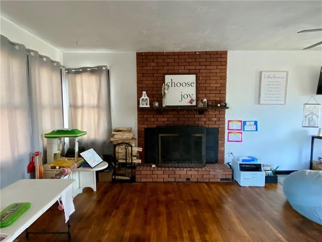 living area featuring a fireplace and wood finished floors