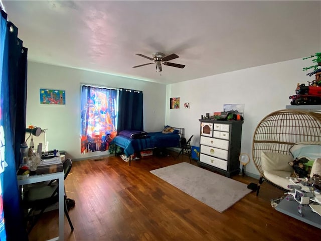 bedroom with a ceiling fan and wood finished floors