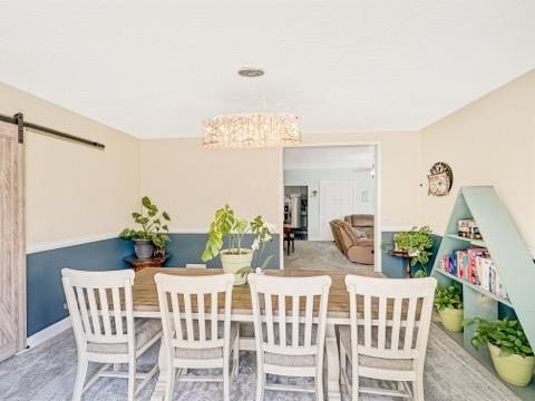 525 N 7th St, Charleston, IL 61920 - dining area featuring a barn door and baseboards